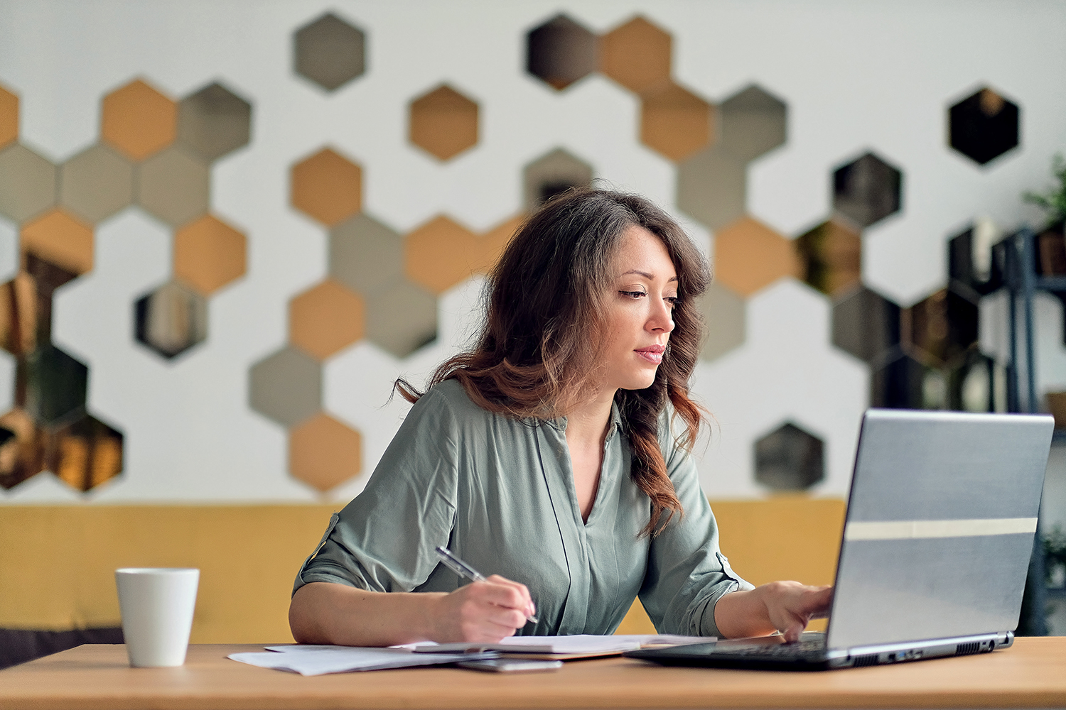 Young woman working from home office.